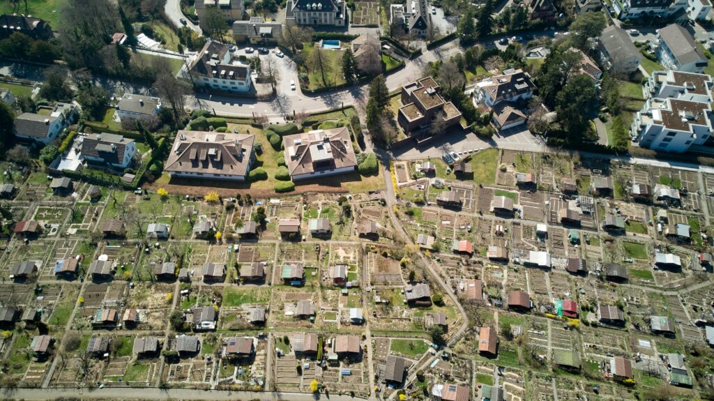 Drone shot of residential homes and gardens in sunny Zürich, Switzerland.